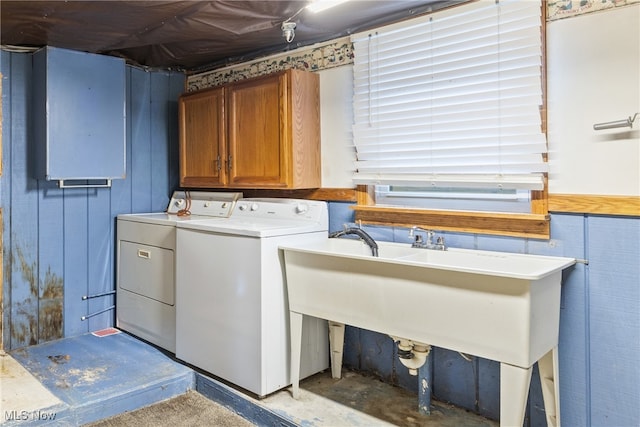 washroom with washing machine and clothes dryer and cabinets