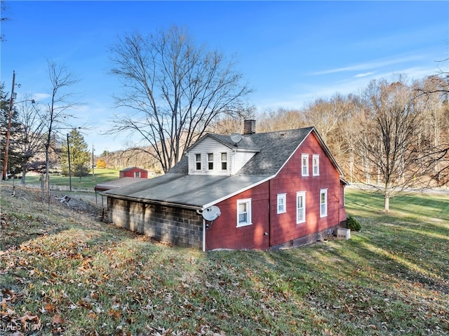 view of side of home featuring a lawn