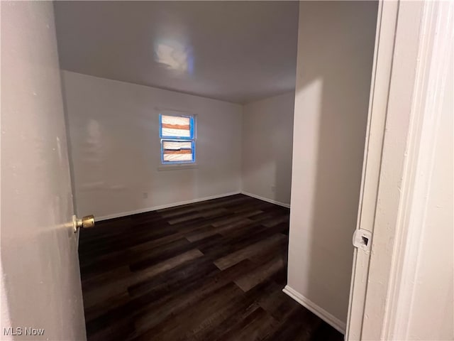 spare room with dark hardwood / wood-style floors