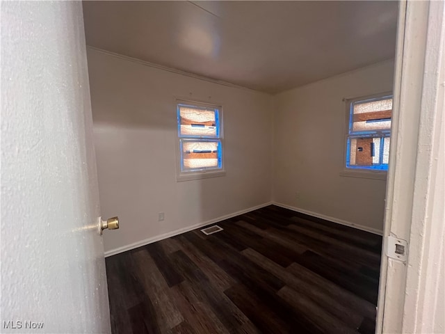 unfurnished room with dark hardwood / wood-style floors