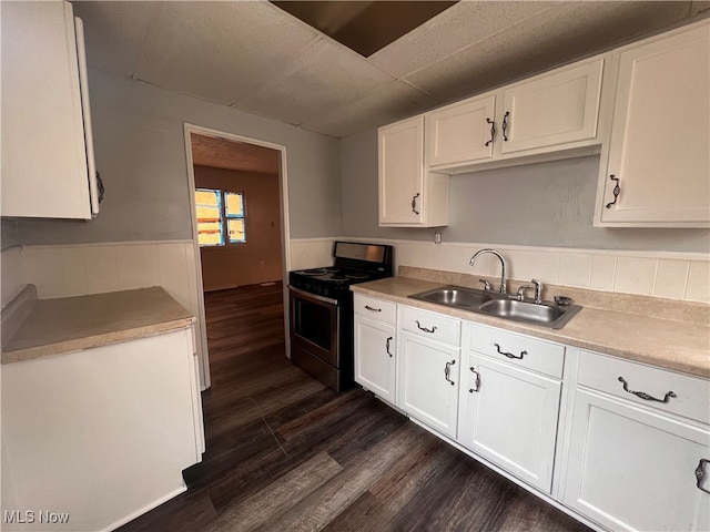 kitchen featuring white cabinetry, stainless steel gas stove, sink, and dark hardwood / wood-style floors