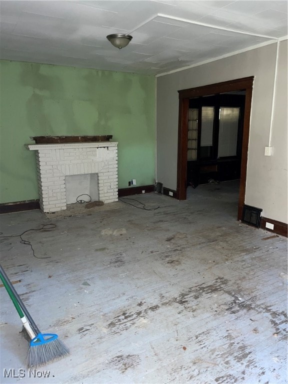 unfurnished living room featuring a brick fireplace