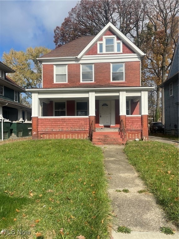 view of front of house featuring covered porch and a front lawn