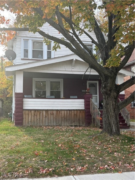 view of side of property with covered porch