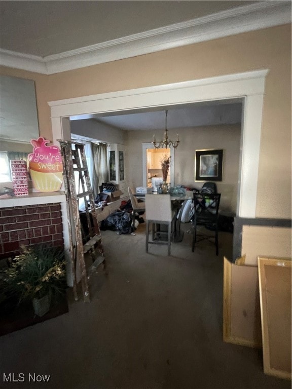 dining space featuring an inviting chandelier, carpet floors, and crown molding