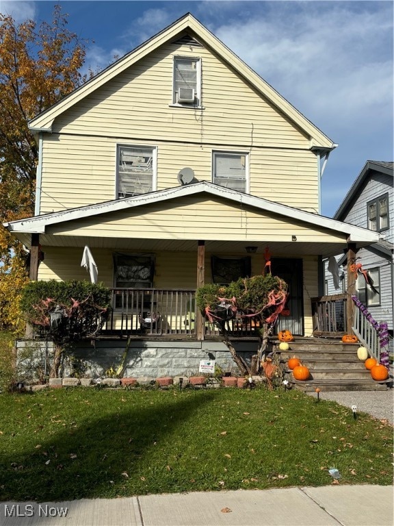 view of front of house featuring a front lawn and covered porch