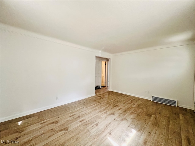 empty room with light hardwood / wood-style flooring