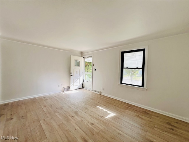 spare room with light hardwood / wood-style flooring