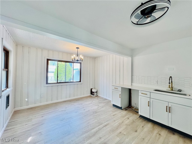 interior space featuring light hardwood / wood-style floors, sink, and an inviting chandelier