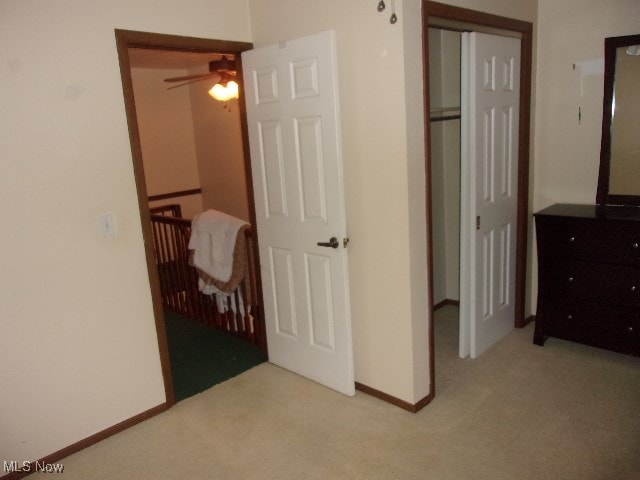 bedroom with light carpet and a closet