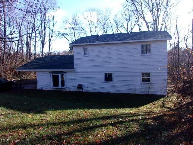 139 Melinda Dr, Wintersville, OH 43953 - back of house featuring a yard