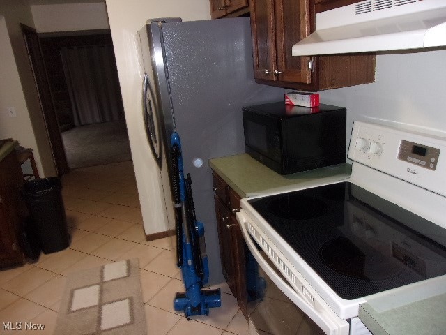 kitchen with light tile patterned floors and electric stove