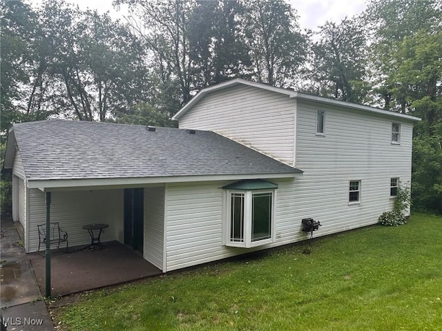 139 Melinda Dr, Wintersville, OH 43953 - back of house featuring roof with shingles, a yard, and a patio area