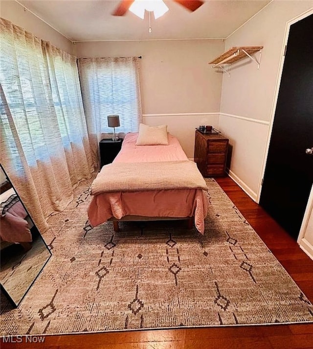 bedroom featuring ceiling fan and dark hardwood / wood-style flooring