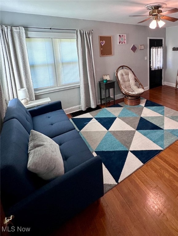 living room with hardwood / wood-style floors and ceiling fan