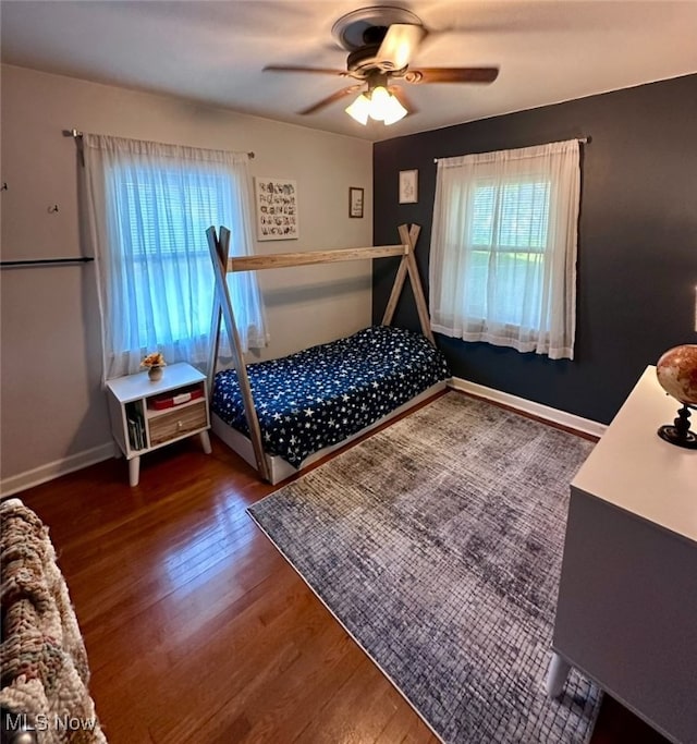 bedroom with dark wood-type flooring and ceiling fan