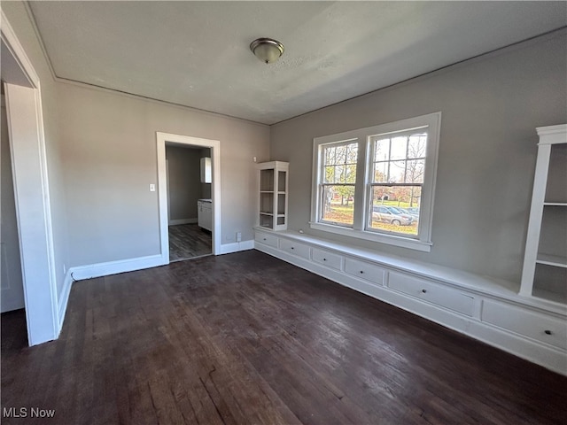 empty room featuring dark wood-type flooring