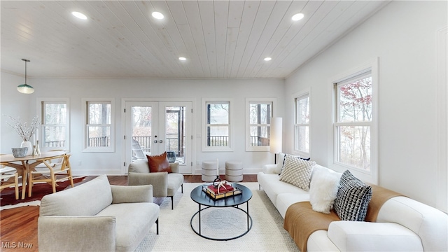 sunroom with wood ceiling, french doors, and a healthy amount of sunlight