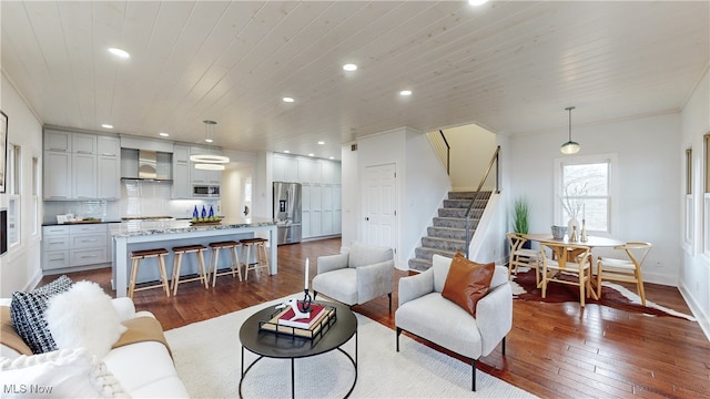 living room with wooden ceiling, crown molding, and dark hardwood / wood-style flooring