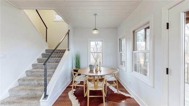 dining space featuring dark hardwood / wood-style flooring and wooden ceiling