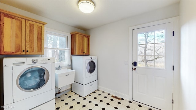 laundry room featuring cabinets, sink, and independent washer and dryer