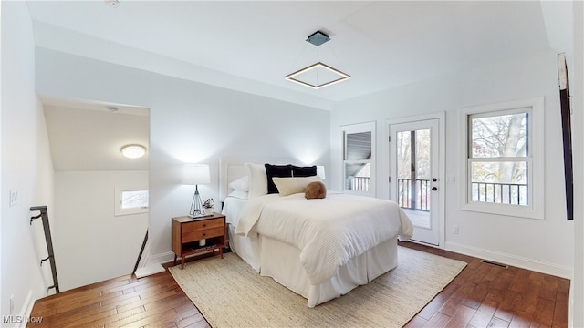 bedroom with dark wood-type flooring and access to exterior