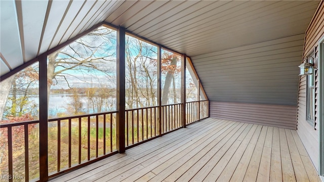 unfurnished sunroom with a water view and vaulted ceiling