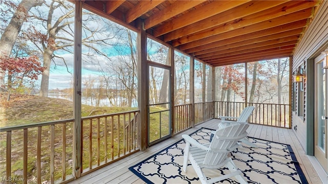 unfurnished sunroom featuring plenty of natural light and a water view