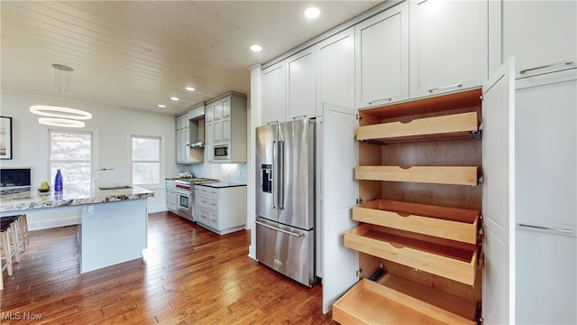 kitchen featuring dark hardwood / wood-style floors, light stone countertops, decorative backsplash, high quality appliances, and white cabinets