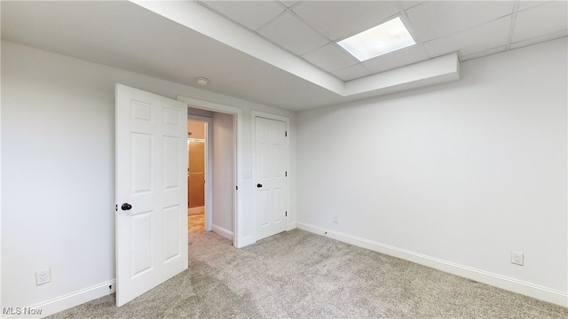 interior space with light carpet and a drop ceiling