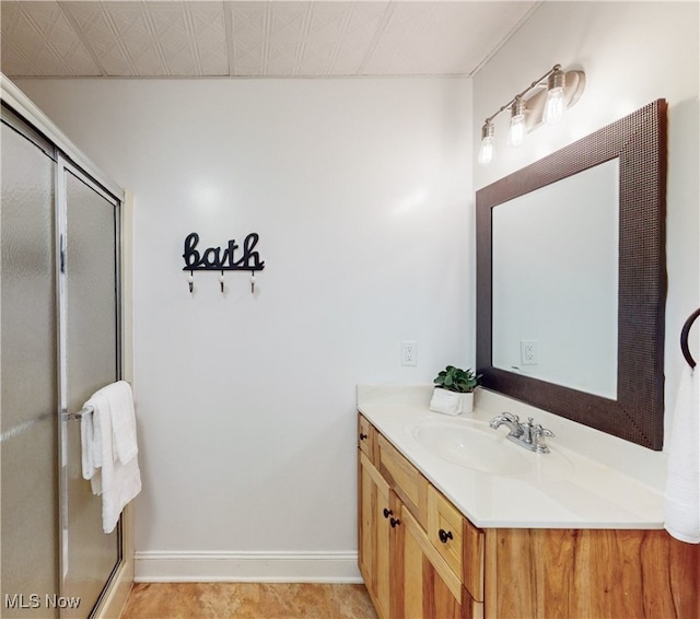 bathroom featuring vanity, tile patterned floors, and a shower with shower door