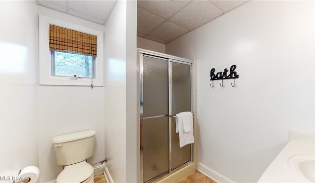 bathroom with walk in shower, vanity, and toilet