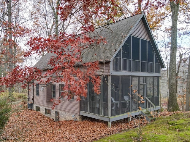 view of home's exterior with a sunroom