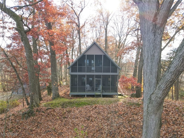 view of outdoor structure featuring a sunroom