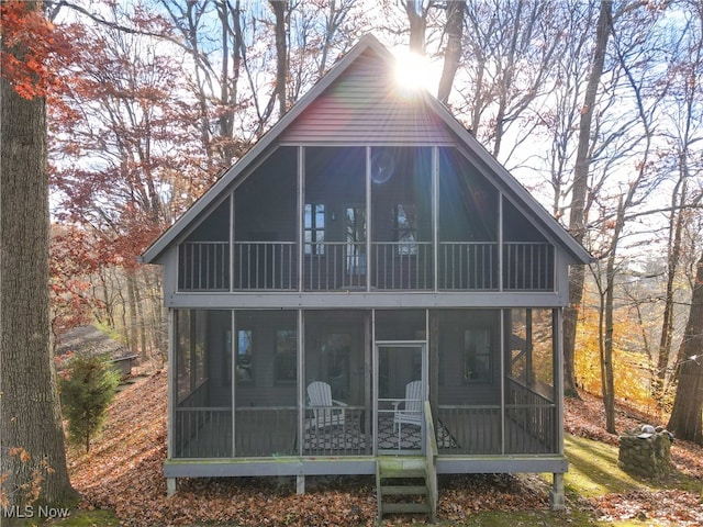 back of house with a sunroom