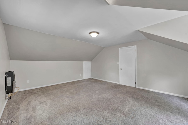 bonus room featuring vaulted ceiling and carpet floors