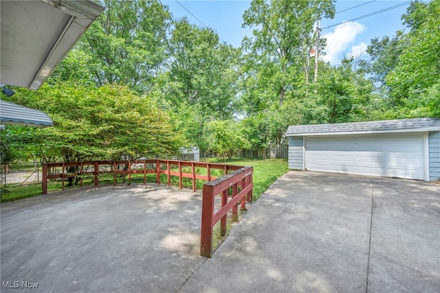 view of patio featuring an outbuilding and a garage