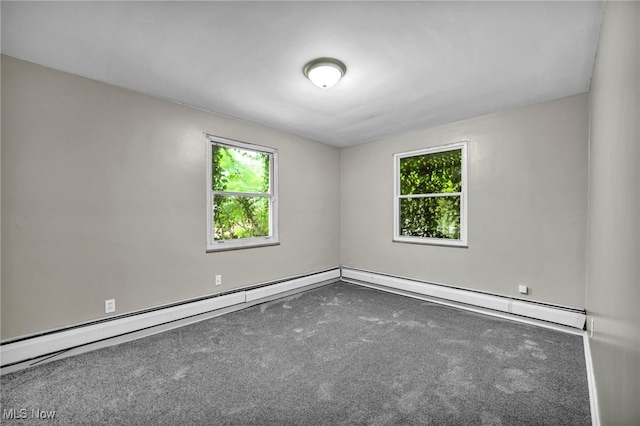 carpeted spare room featuring a baseboard heating unit