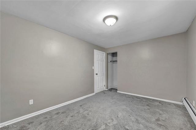 spare room with a baseboard radiator and carpet