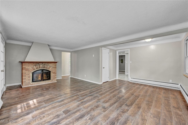 unfurnished living room with hardwood / wood-style floors, a baseboard radiator, a textured ceiling, and a brick fireplace