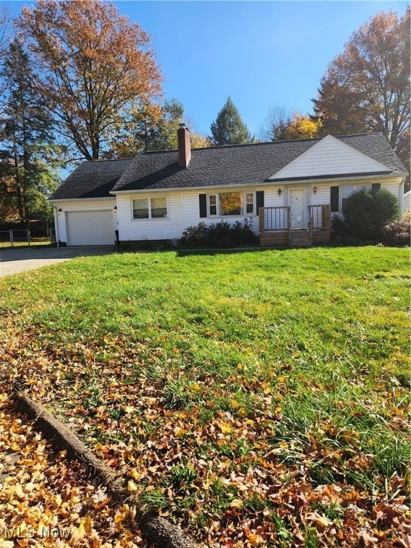 single story home featuring a front lawn and a garage