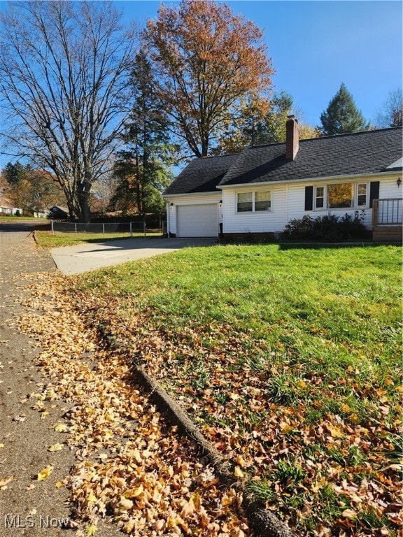 view of side of home with a yard and a garage