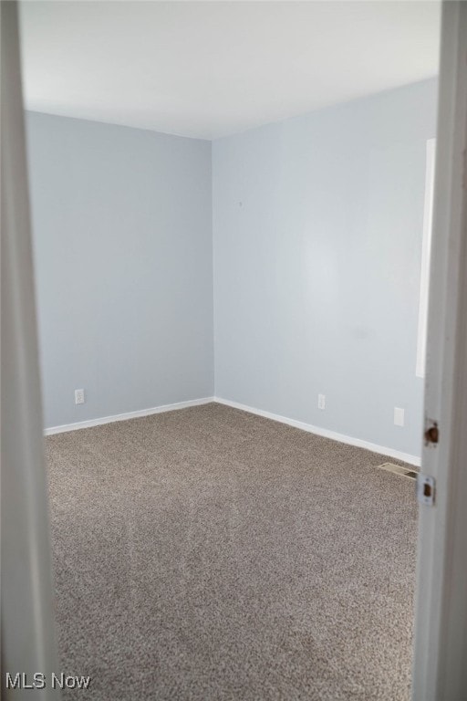 unfurnished room featuring carpet flooring