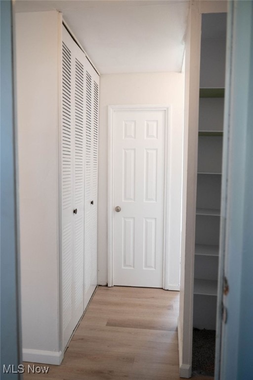 hall with light hardwood / wood-style floors