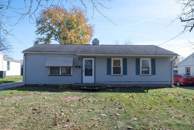 view of front of property featuring central air condition unit and a front yard