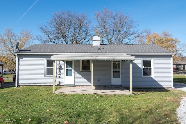 back of house featuring a patio and a yard