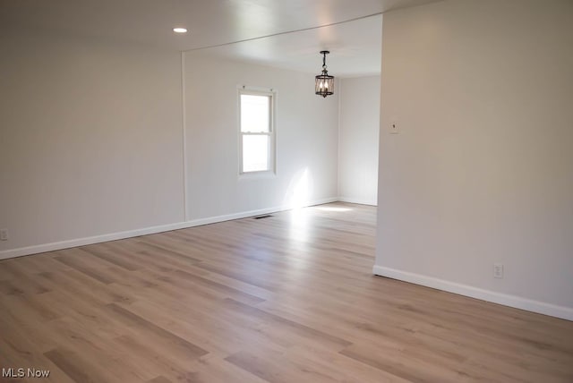 unfurnished room featuring light wood-type flooring