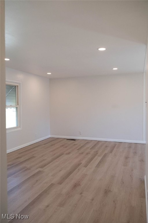 spare room featuring light wood-type flooring