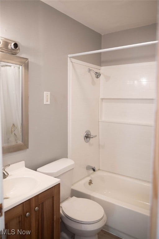 full bathroom featuring toilet, vanity, and washtub / shower combination