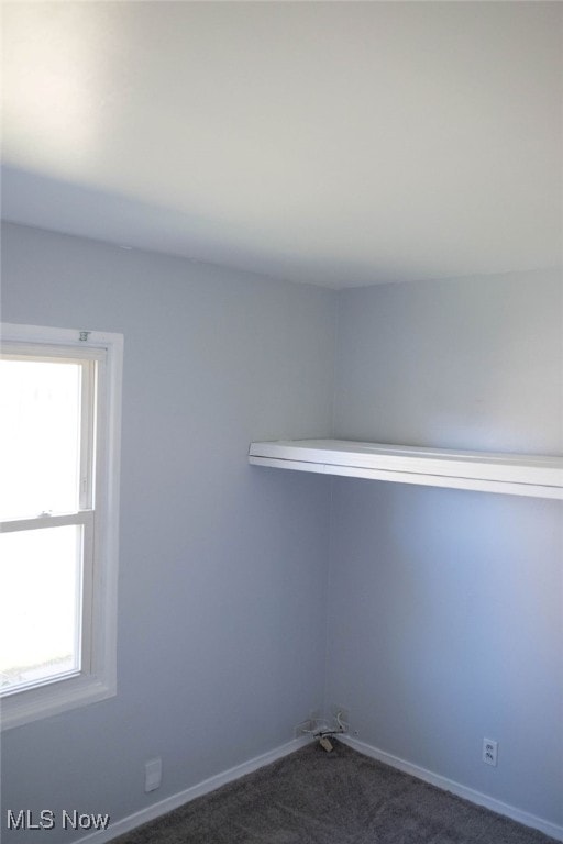 carpeted spare room featuring a wealth of natural light